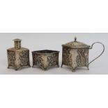 A Chinese silver cruet set cast with foliage comprising; salt cellar, pepper pot and mustard pot (