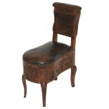 A French walnut bidet with leather hinged seat, back and rest, the frame carved with rococo