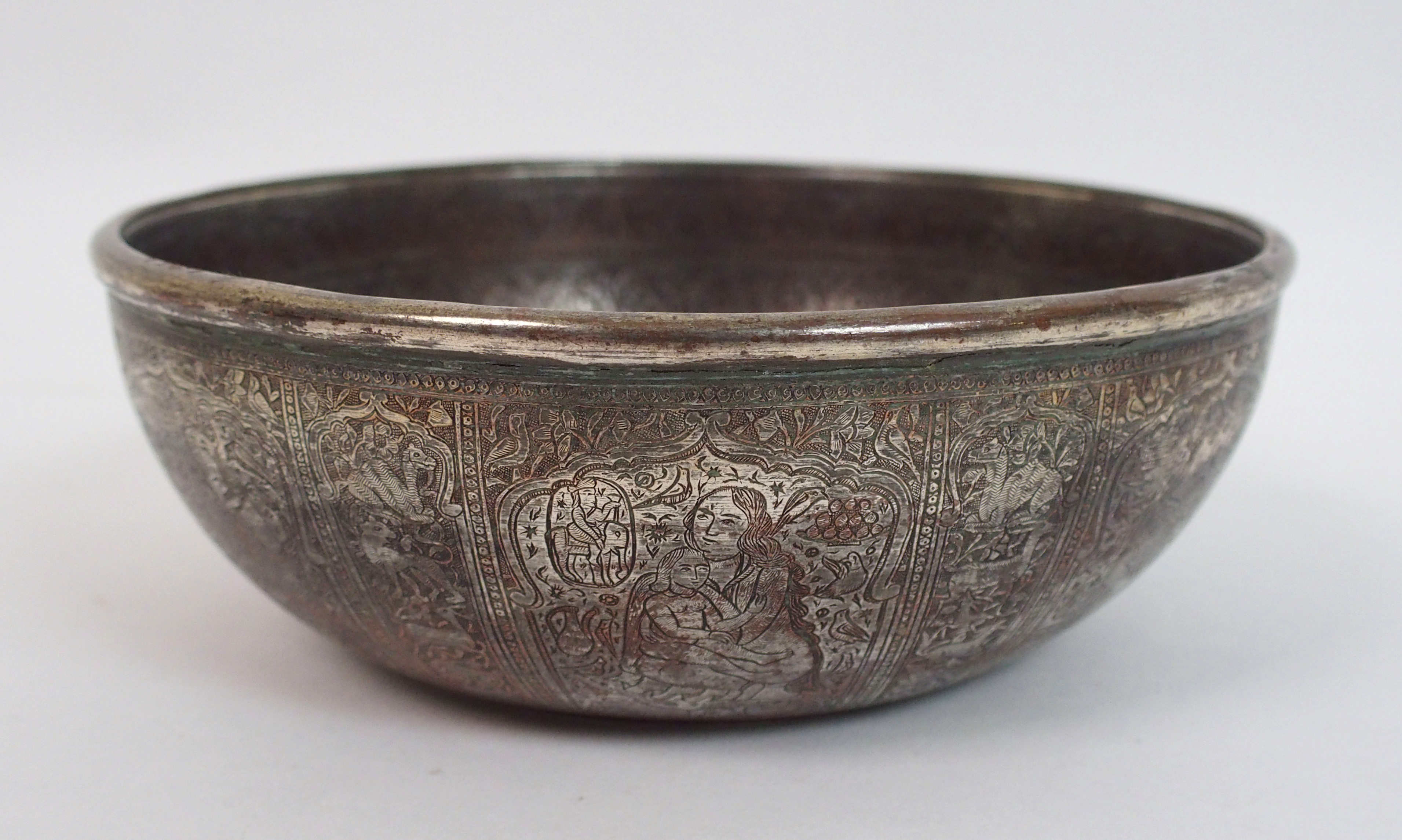 A Bidri ware brass bowl decorated with panels of noble figures divided by animals, calligraphy and