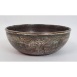 A Bidri ware brass bowl decorated with panels of noble figures divided by animals, calligraphy and