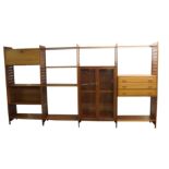 A Ladderax teak display shelving system by Staples comprising; two door glazed cupboard, drop