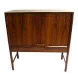 A 1960's rosewood sideboard/drinks cabinet with two cupboard doors over two drawers by A