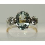 An 18ct gold aquamarine and diamond three stone ring Combined estimated approx diamond total is 0.