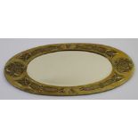 A Glasgow School of Art Arts and Crafts style brass framed mirror of oval form with Celtic