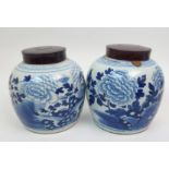 A pair of Chinese blue and white jars painted with peonies issuing from rock work, below key pattern