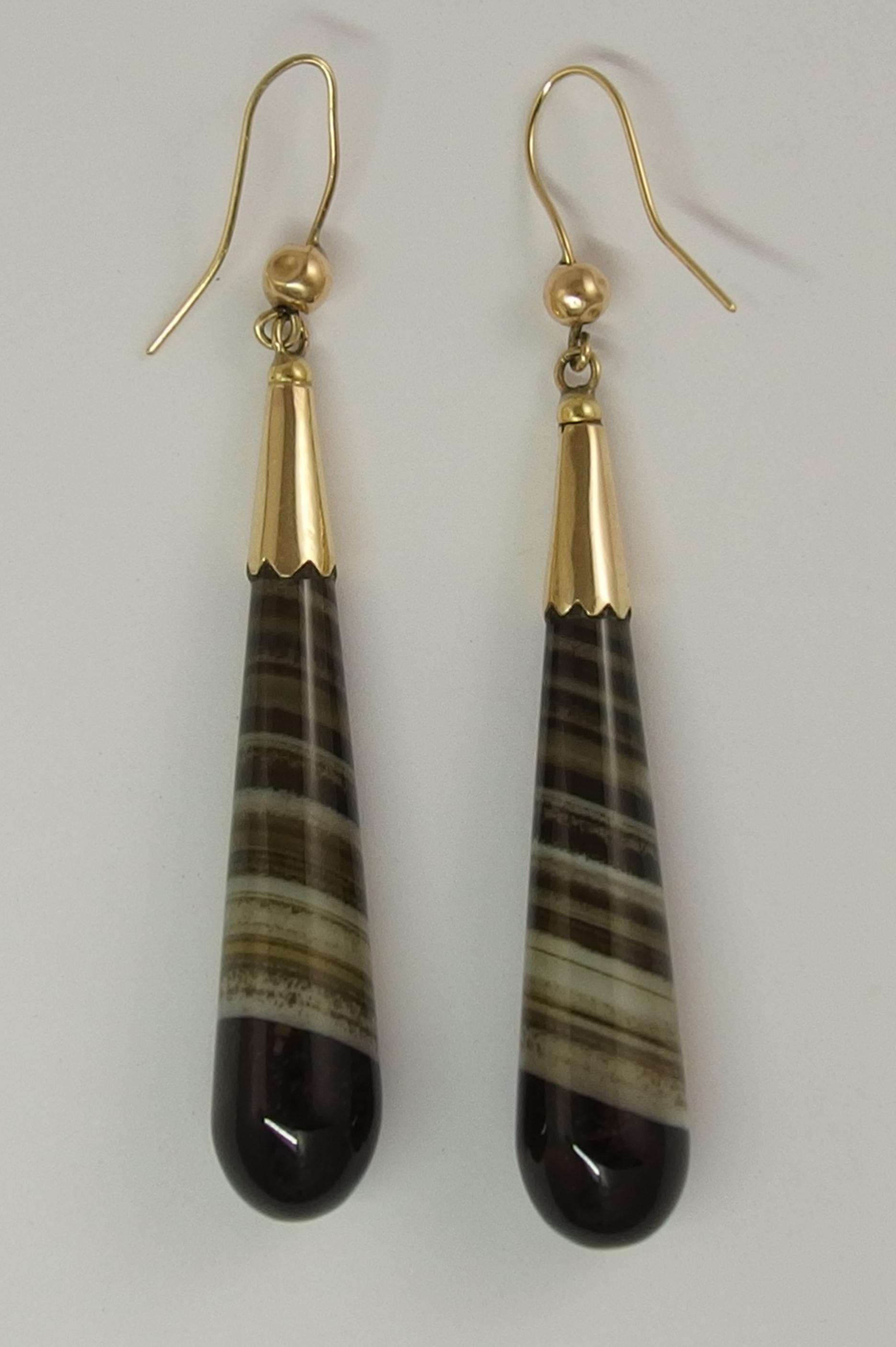 A pair of banded agate earrings of long drop shape with yellow metal ear wires, length 68mm