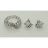 An Eric Smith diamond ring with matching earrings of brilliant cut set square profile, twisted