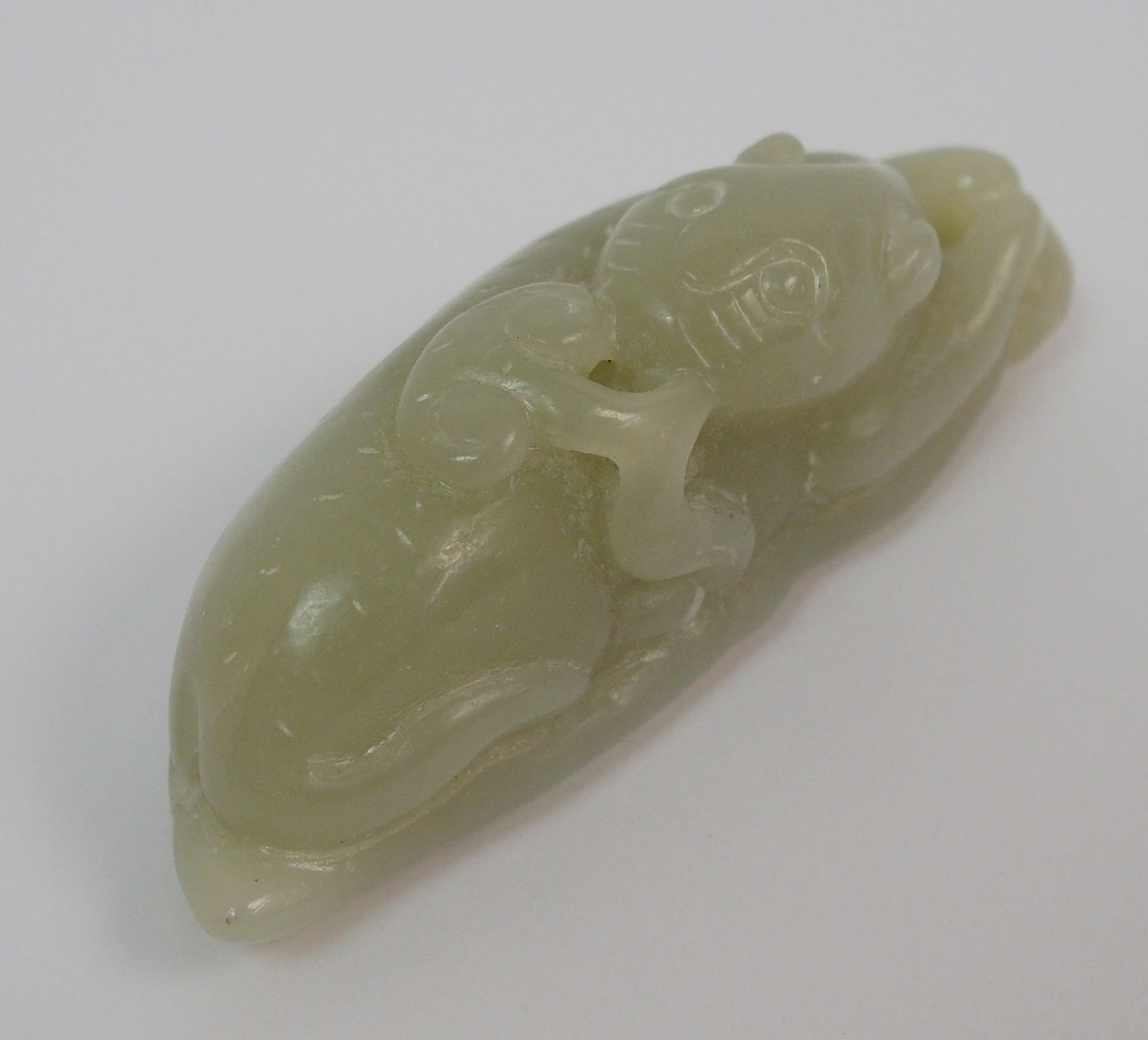 A Chinese hardstone carving of a feline recumbent with scroll in mouth and resting on a leaf, 7. - Image 8 of 10