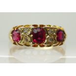 An 18ct gold ruby and rose cut diamond ring in scalloped setting with engraved shoulders, finger