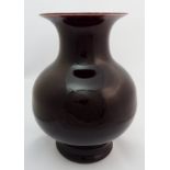 A Chinese red flambe baluster vase with broad bulbous body on a shaped foot, 32cm high