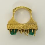 An 18ct gold retro ring set with natural emerald crystals with a sculptural textured shank and