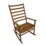 A Danish ash ladder-back rocking chair with rush seat, label to base, 105cm tall