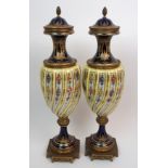 A pair of Sevres style gilt bronze and porcelain vases the ribbed bodies with gilt and painted