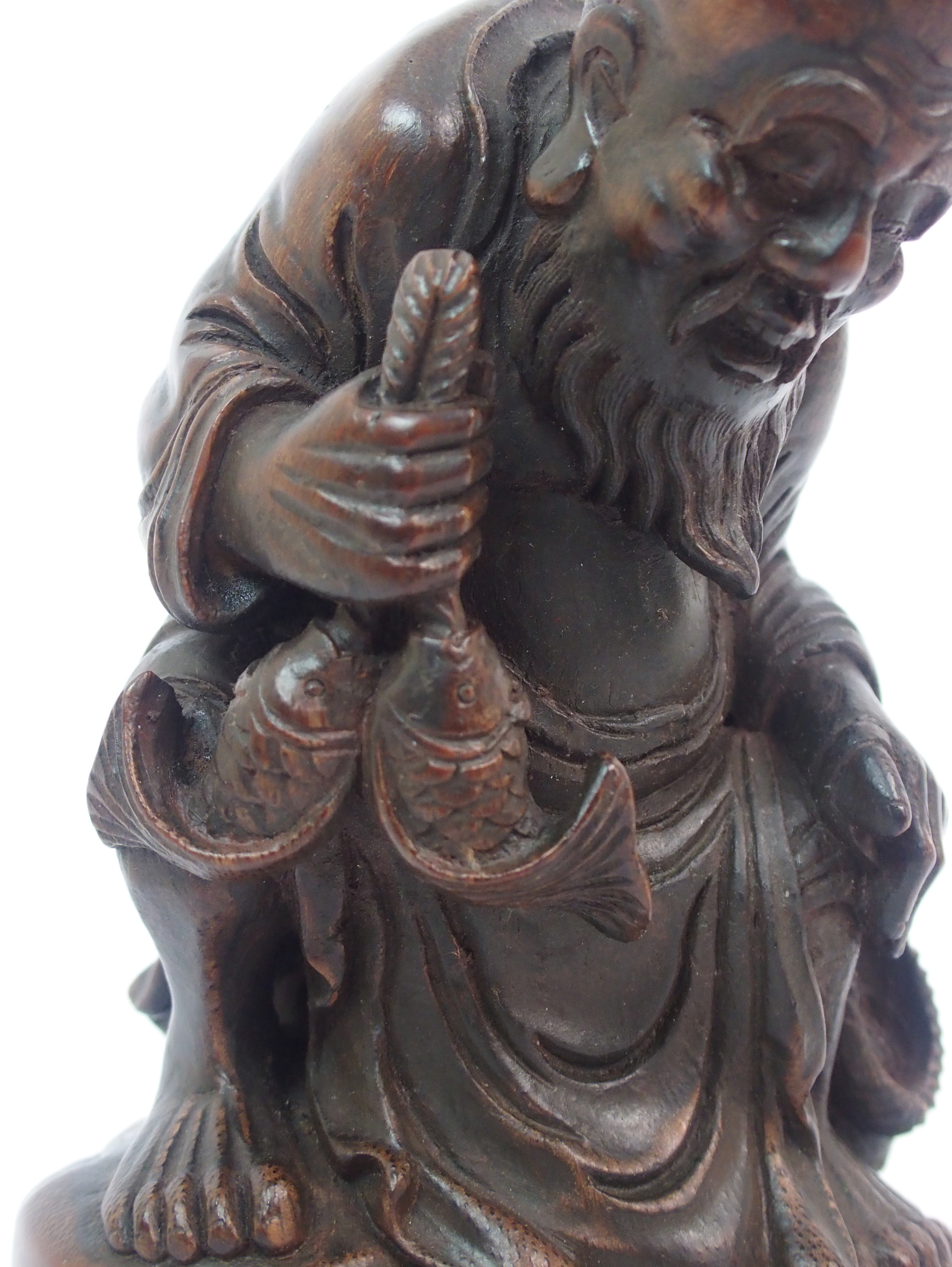 A Chinese bamboo figure of a fisherman seated on a rock above a young boy holding a fish amongst - Image 4 of 10