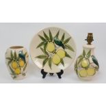 A Moorcroft Lemon Tree pattern vase designed by Sally Tuffin, depicting a blue bird sat in a lemon