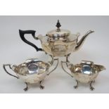 A three piece silver tea service by Walker & Hall, Sheffield 1913, of tapering circular form with