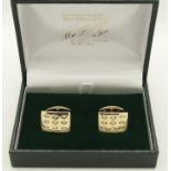 A pair of 9ct gold diamond set cufflinks each set with nine diamonds in a lattice pattern, head size