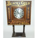 A Black & Gold Whisky advertising clock the oak case with painted advertising text on barley twist