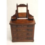 A Victorian walnut apprentice dressing chest the swing mirror and open shelves above two over