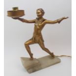 An Art Deco spelter table lamp modelled as a dancing woman with one leg raised on an onyx step,