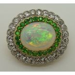 A Marcus & Co opal diamond and green gem brooch possibly diopside, the central opal has good