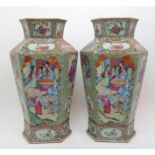 A pair of Canton hexagonal famille rose vases painted with panels of mandarins and courtesans,