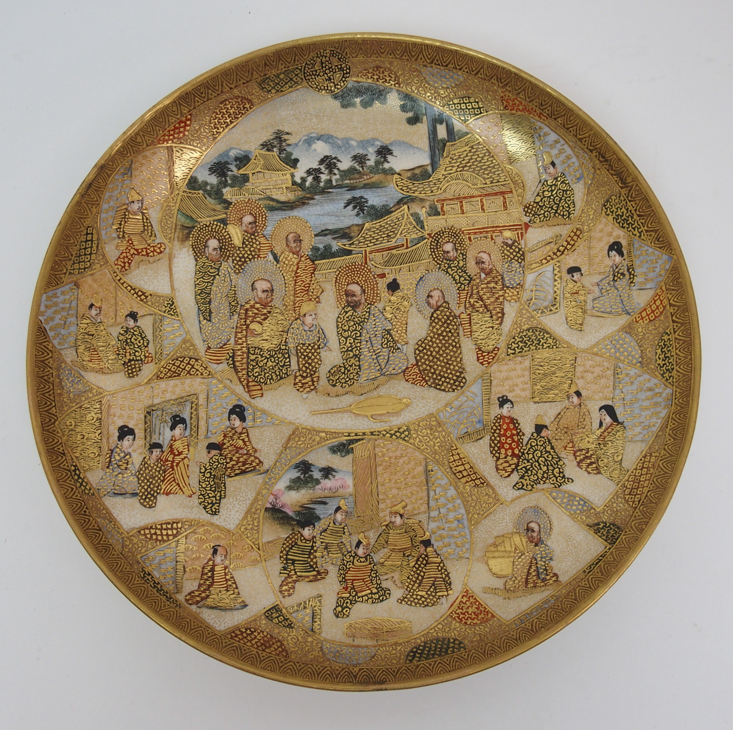 A Satsuma dish painted with Sennin and panels of figures within vignettes and amongst gilt diaper