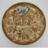 A Satsuma dish painted with Sennin and panels of figures within vignettes and amongst gilt diaper