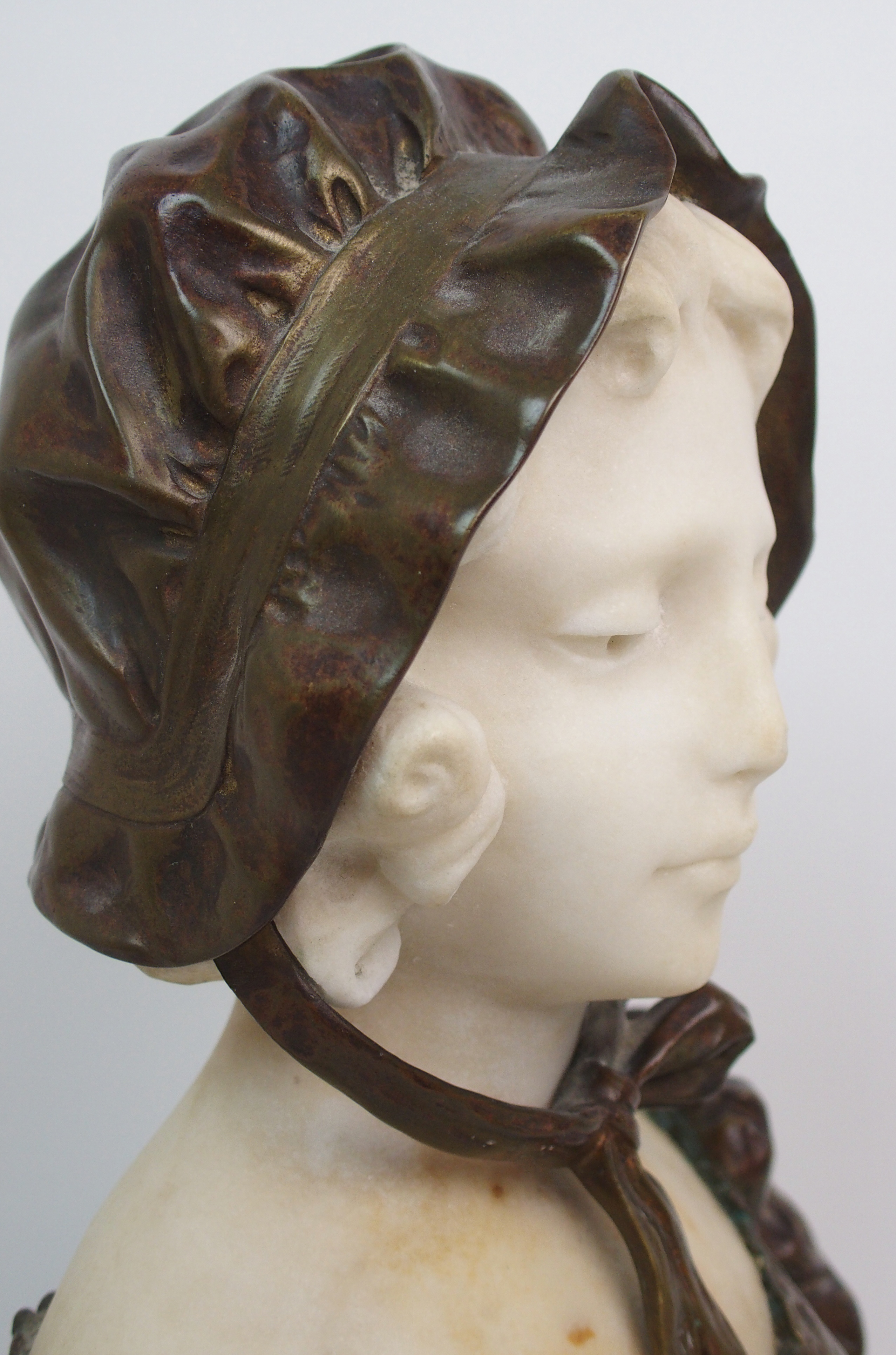 Affortunato Gory (active 1895-1925) Bronze and alabaster bust of a girl modelled wearing a bonnet, - Image 5 of 10