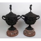 A pair of 19th century continental twin-handled patinated bronze urns decorated in high relief
