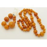 A string of amber coloured beads largest round bead 23.9mm x 21.4mm, smallest 7.38mm x 6.4mm.