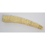 An Anglo-Portuguese ivory carved tusk decorated with a band of animals, band of tied figures, band