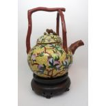 A large Chinese cloisonne teapot decorated with peaches and foliage on a yellow ground, branch