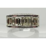 An 18ct white gold substantial four emerald cut, brilliant and baguette diamond ring the four