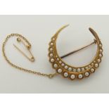 An 18ct gold crescent moon brooch set with split pearls, maker Saunders & Shepherd, circa 1893 -