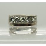 An 18ct white gold five stone diamond ring stamped with the makers mark 'Larry' the diamonds have an