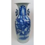 A Chinese blue and white vase painted with a village scene, beneath pierced foliate handles, 58cm