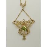 A bright yellow metal peridot and pearl Edwardian pendant with a fancy chain, length of pendant 5.