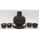 A Chinese coconut and silver mounted set comprising; bottle decanter and stopper, 15cm high,