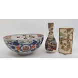 An Imari export bowl painted with galleons divided by Europeans, above an exotic bird medallion (