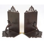 A pair of Secessionist patinated brass bookends each modelled as a leaping deer, the ends with