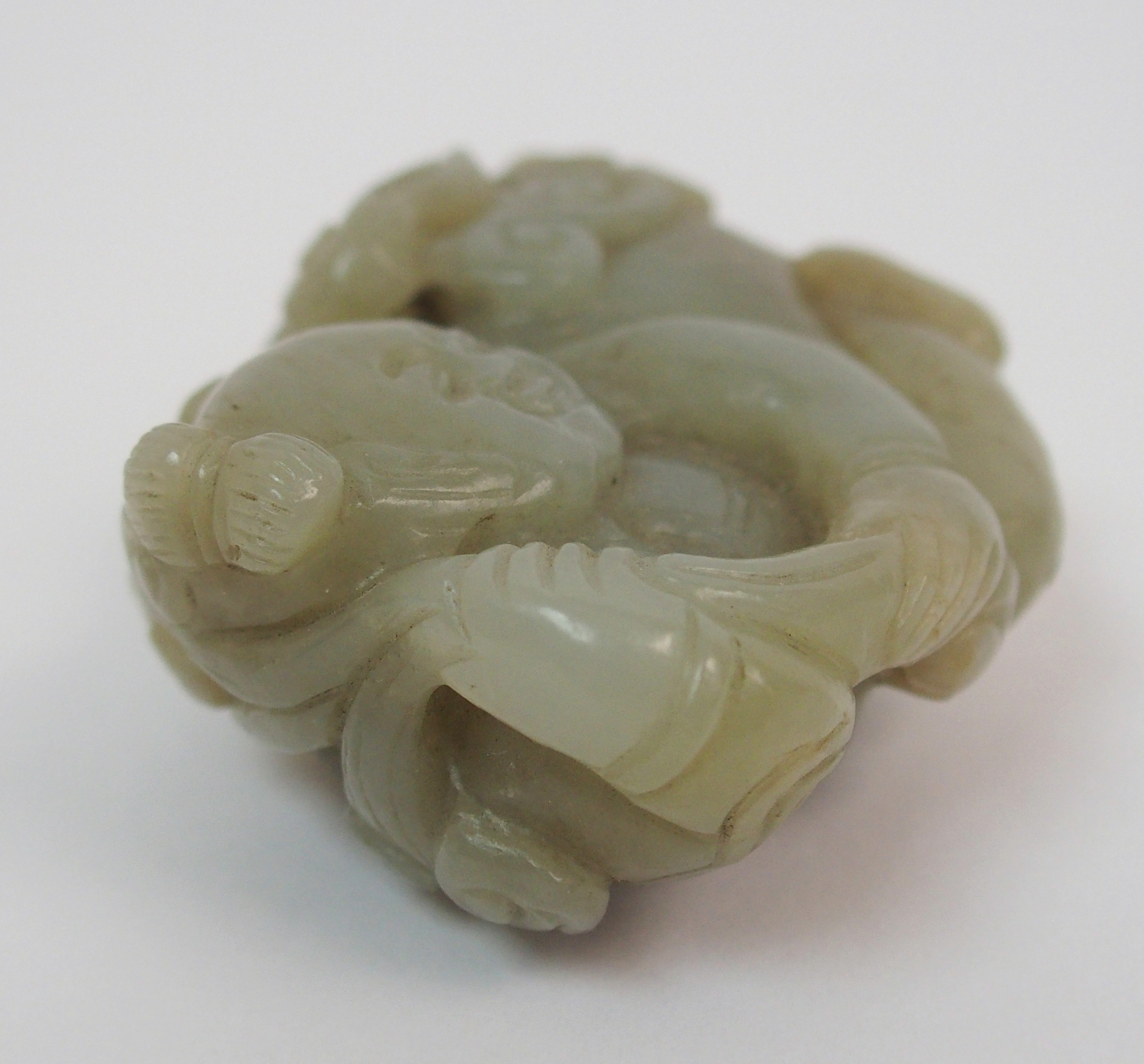 A Chinese jade carving of a child lying and holding lingzhi frond, 7cm wide - Image 4 of 10