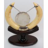 An Edwardian warthog horn and silver-mounted gong stand Edinburgh 1903, makers mark JR on carved oak