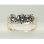 An 18ct three stone diamond ring the three diamonds are crown mounted to a tapered yellow gold