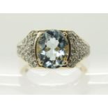 A 9ct gold aquamarine and diamond ring the oval facet cut aquamarine is approx 10mm x 8mm x 5mm,