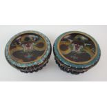 A pair of Chinese cloisonne dragon bowls of traditional type, with carved wood stands, 14cm diameter