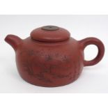 A Yixing teapot and cover carved with foliage and calligraphy, signed, 16cm wide