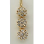 An 18ct yellow gold Iliana diamond flower pendant three diamond set flowers with an estimated approx