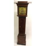A 19th Century oak longcase clock the 8 day movement with brass face and Roman numerals and cherub