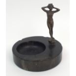 An Art Deco veined black marble trinket dish with bronzed figure of a lady in swimming costume,